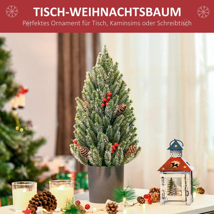 Snow-covered table Christmas tree with berries and pine cones