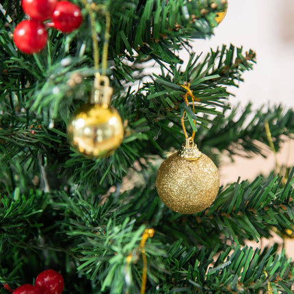 Small green Christmas tree with LED lights and berries