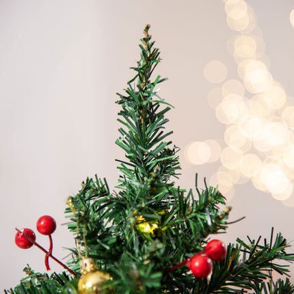 Small green Christmas tree with LED lights and berries