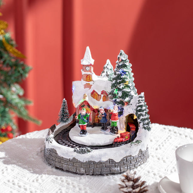 Christmas village with LED lights and moving train