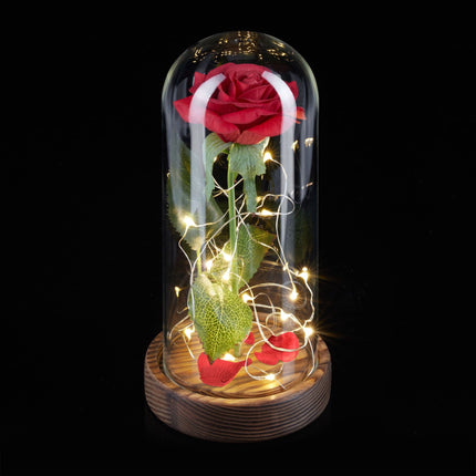Eternal rose in glass with candle