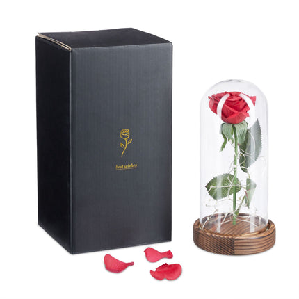 Eternal rose in glass with candle