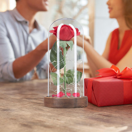Eternal rose in glass with candle