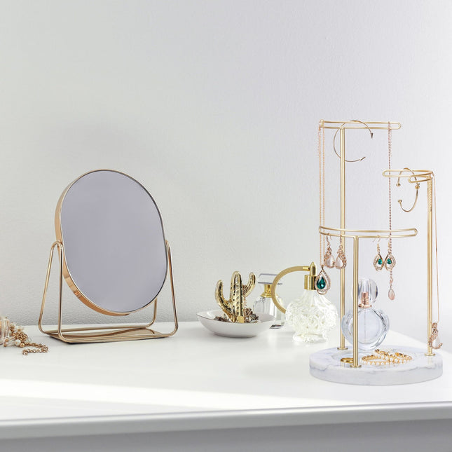 Gold colored jewelry stand with marble base
