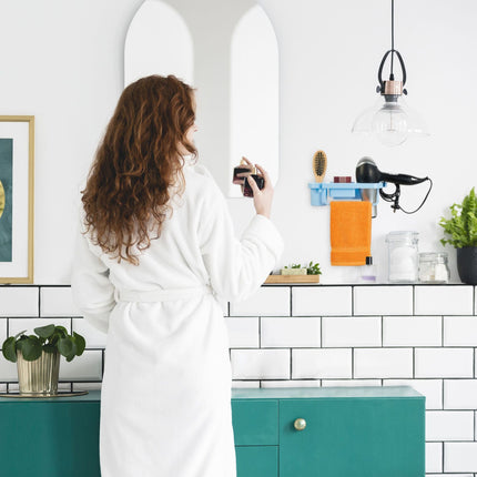 Hair dryer holder for the wall