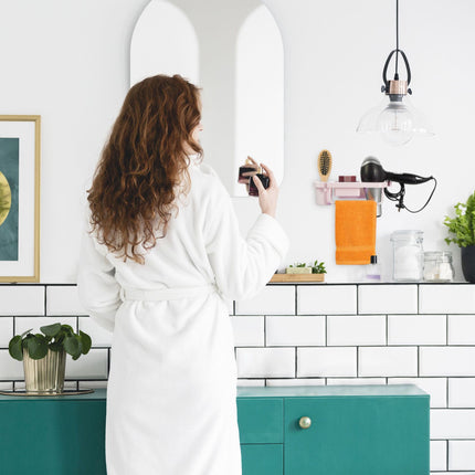 Hair dryer holder for the wall