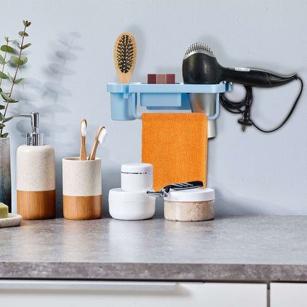 Hair dryer holder for the wall