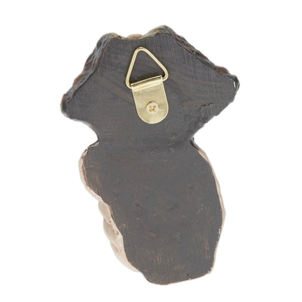 Wooden face with resting gesture